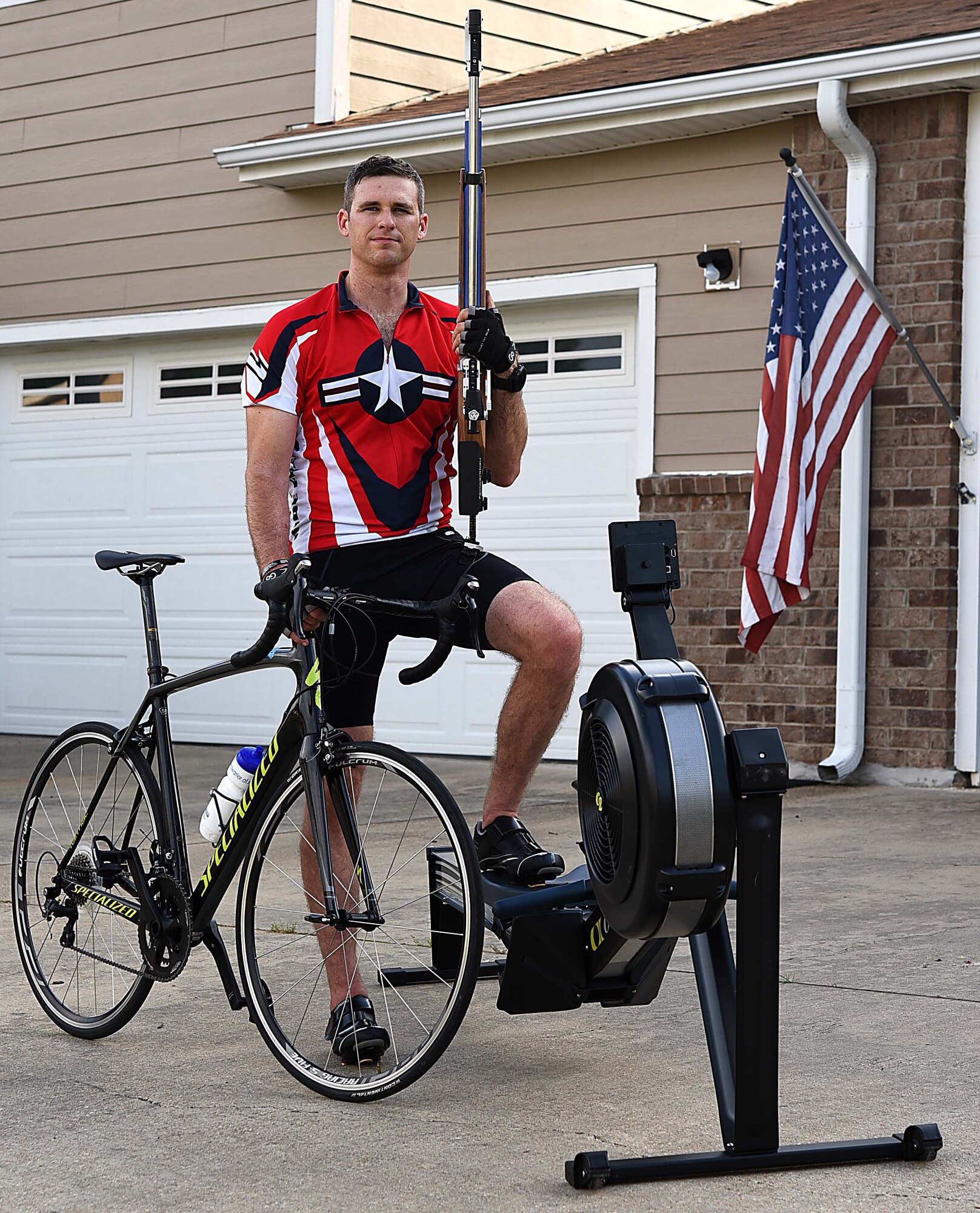 Capt. Hunter Barnhill, 37th Flying Training Squadron instructor pilot, stands with his training equipment May 15, 2018, on Columbus Air Force Base, Mississippi. Barnhill qualified for the Air Force Wounded Warrior team in the shooting, cycling and indoor rowing events. He will be competing in all three events at the 2018 Warrior Games June 1-9 at the U.S. Air Force Academy in Colorado Springs, Colorado. (U.S. Air Force photo by Airman 1st Class Keith Holcomb)