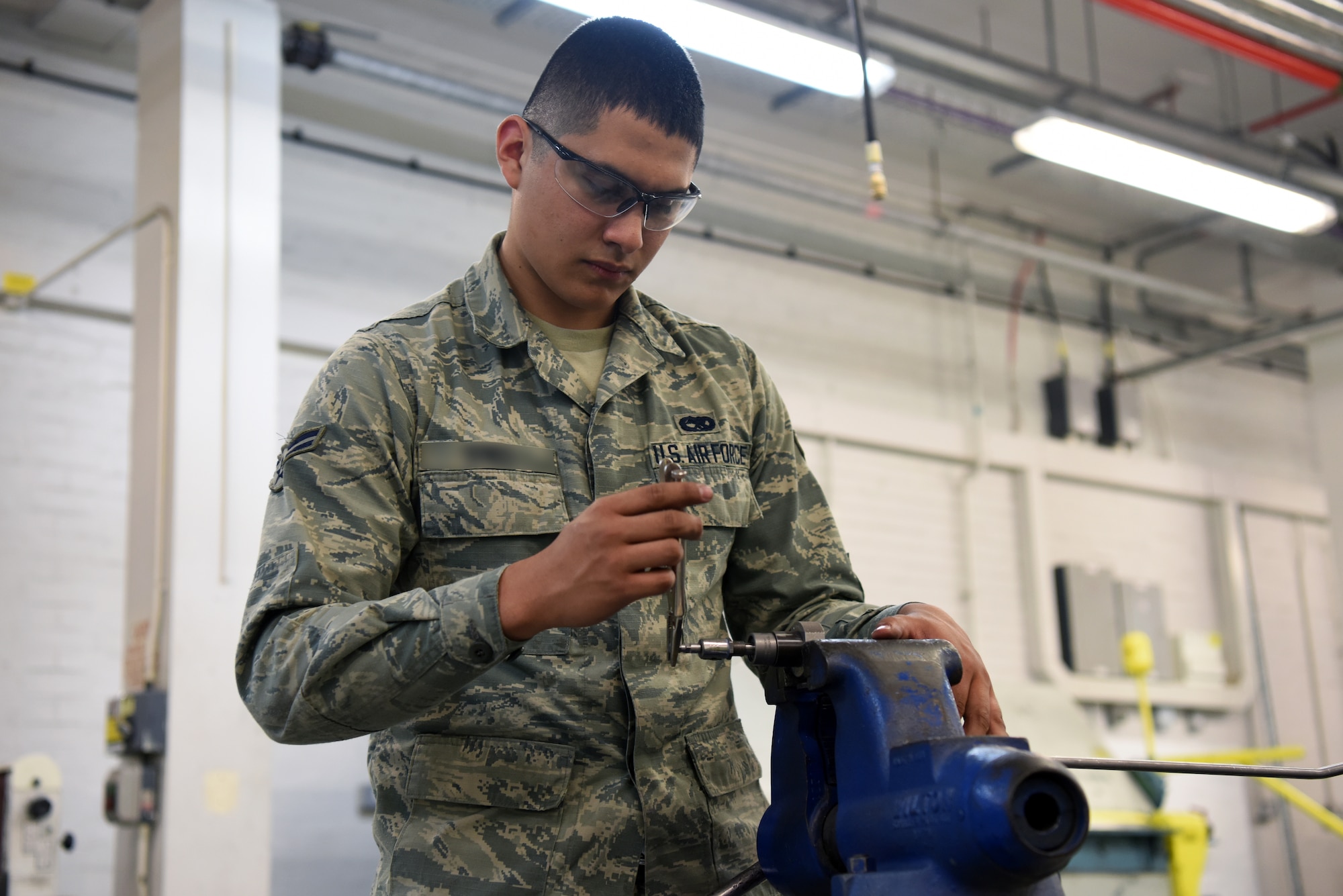 A 48th Aircraft Structural Maintenance Airman tightens a fastener on a control line at Royal Air Force Lakenheath, England, May 22, 2018. Aircraft Structural Maintainers work on both the external skin of the aircraft and the internal support structure that holds the exterior in place.