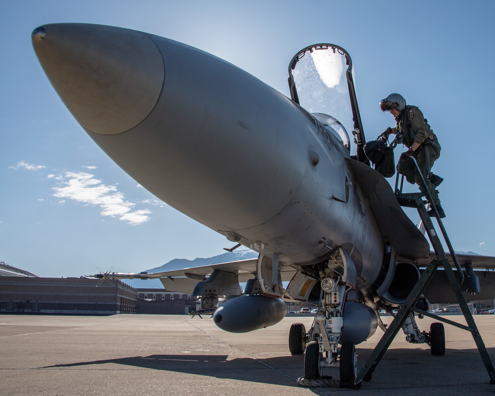 Royal Canadian Air Force pilot Capt. Jason Berndt, assigned to the 433rd Tactical Fighter Squadron, climbs a ladder to the cockpit of an F-18A fighter jet May 3, 2018, at Hill Air Force Base, Utah. The Canadian unit participated in a Weapons Evaluation Systems Program, or WSEP, exercise conducted by the 86th Fighter Weapons Squadron, a Hill tenant unit. (U.S. Air Force photo by R. Nial Bradshaw)