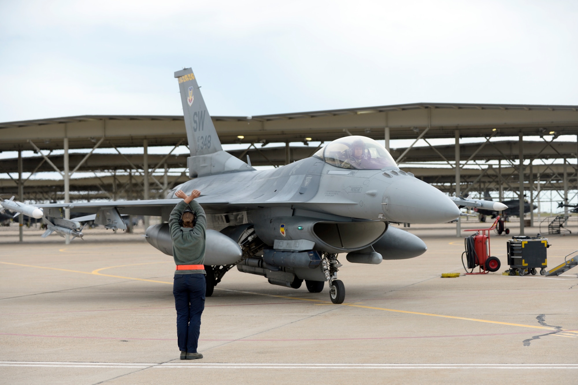 Airman 1st Class Krystin Bartelt, 79th Fighter Squadron, provides recovery support for an F-16 from Shaw Air Force Base, South Carolina, after a training mission, May 10, 2018, at Hill Air Force Base, Utah. The unit participated in a Weapons System Evaluation Program, or WSEP, exercise conducted by the 86th Fighter Weapons Squadron, a Hill tenant unit. (U.S. Air Force photo by Todd Cromar)