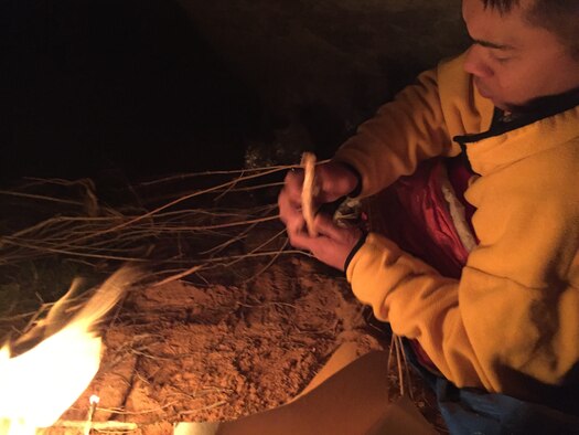 Senior Airman Matthew Ronnfeldt, 384th Air Refueling Squadron boom operator, starts a fire to stay warm in Pine Creek Canyon at Zion National Park, Utah, March 17, 2018. Due to a snow storm, Ronnfeldt and 1st Lt. Marclauren Galera (not pictured), 384th ARS pilot, were forced to stay the night in a cave after helping park rangers rescue six climbers. (Courtesy photo)