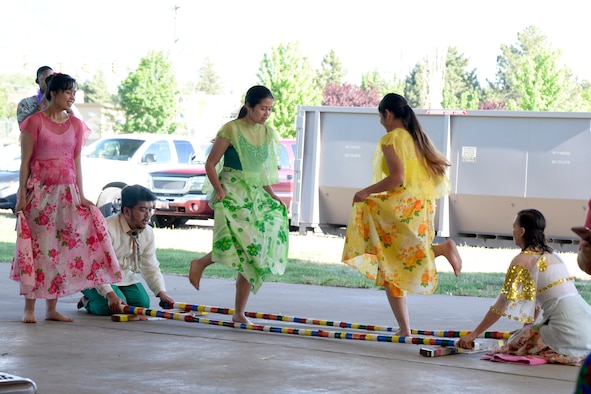 Filipino dancers perform the Tinikling, a traditional cultural dance, at the American Asian Pacific Islander Festival, May 17, 2018, at Hill Air Force Base, Utah. The annual AAPI Festival, held at Centennial Park allowed visitors to experience and enjoy traditional foods, while celebrating the rich, diverse cultures of Asia and the Islands with dances and entertainment. (U.S. Air Force photo by Todd Cromar)