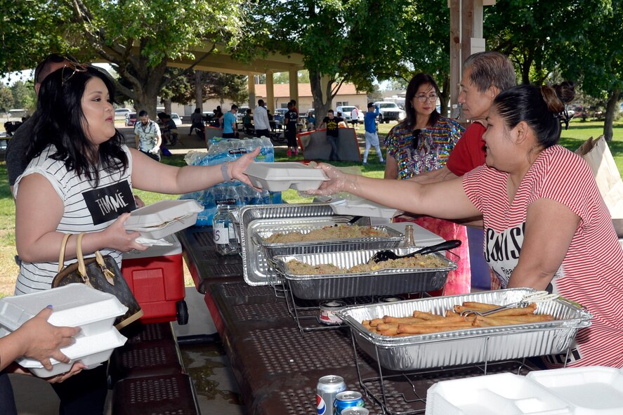 Members of the Utah Filipino Association serve traditional Filipino dishes at the American Asian Pacific Islander Festival, May 17, 2018, at Hill Air Force Base, Utah. The annual AAPI Festival, held at Centennial Park allowed visitors to experience and enjoy traditional foods, while celebrating the rich, diverse cultures of Asia and the Islands with dances and entertainment. (U.S. Air Force photo by Todd Cromar)