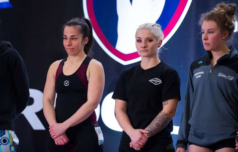 Staff Sgt. Bailey Jewell, center, a compliance assessor with the National Air and Space Intelligence Center Inspector General’s office, stands on stage alongside her competition during the Arnold Sports Festival March 1, 2018 at the Greater Columbus Convention Center in Columbus, Ohio. More than 22,000 athletes from 80 nations attended the festival to compete across 77 sports. (U.S. Air Force photo/Senior Airman Jonathan Stefanko)