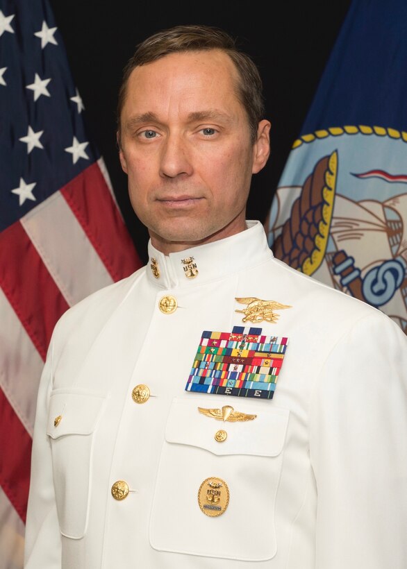 Official portrait of retired Navy Master Chief Petty Officer Britt K. Slabinski in dress-white uniform.