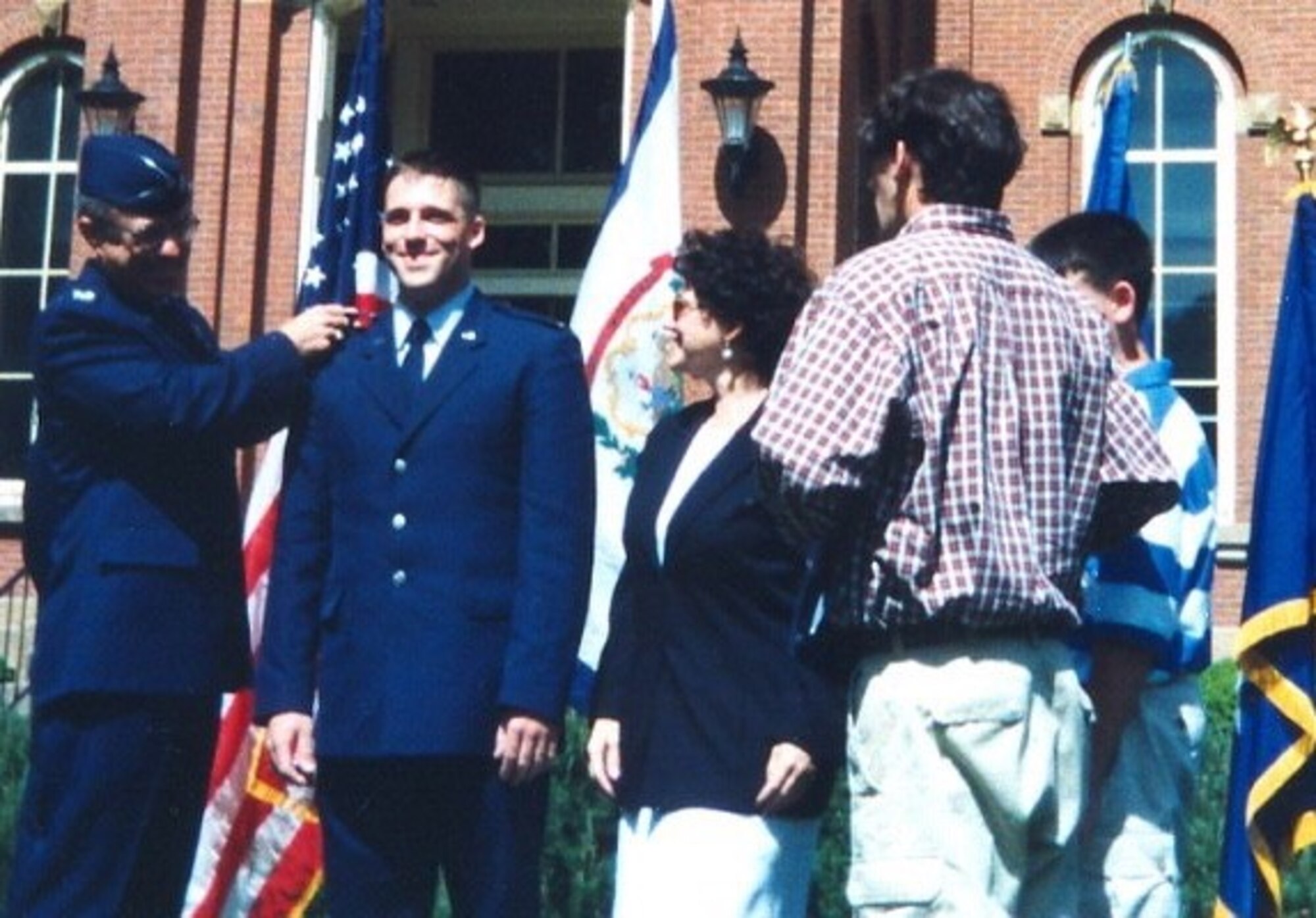 Col. Richard Evans, West Virginia University aerospace science professor and Detachment 915 commander, pins a gold bar on 2nd Lt. Jason Camilletti, WVU ROTC graduate, during his promotion ceremony May 15, 1999.