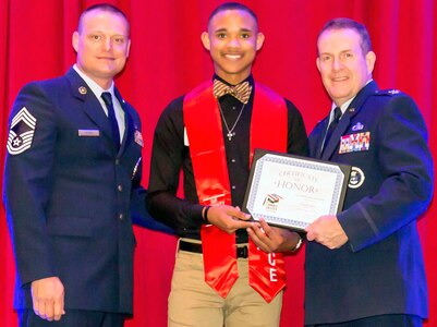 Air Force Col. Sean McKenna, chief of Plans and Resources Division, Headquarters Air Force Recruiting Service, and Chief Master Sgt. William Rawls pose with a future Airman, who was honored during “A Night in Your Honor” hosted by Our Community Salutes-San Antonio held in the Rosenberg Sky Room at the University of the Incarnate Word May 16.