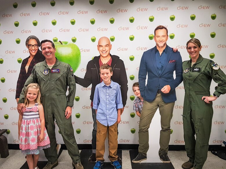 Lt. Col. Maura George, Maj. Derik George and their children pose with The Chew host cutouts prior to joining the hosts on camera as program special guests. (U.S. Air Force photo by Tech. Sgt. Andy Davis, SAF/PAON, NYC)
