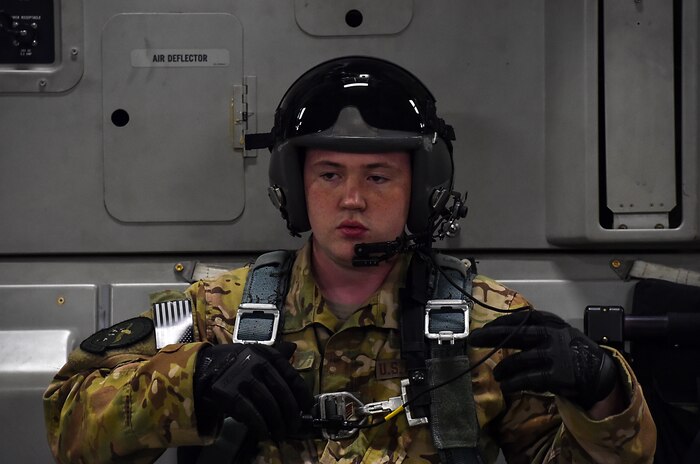Staff Sgt. William Reed, 16th Airlift Squadron loadmaster, sits in the cargo bay of a C-17 Globemaster III during the large formation exercise at Joint Base Charleston, S.C., May 22, 2018.
