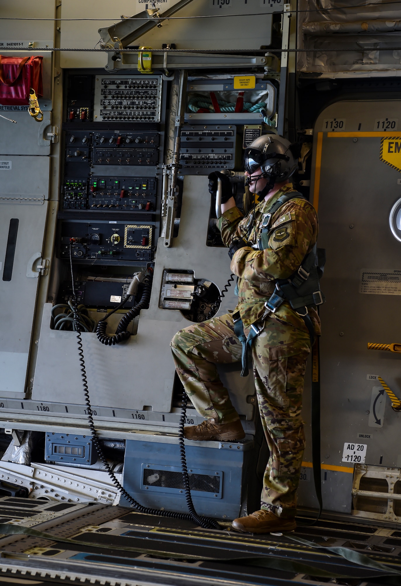 Staff Sgt. William Reed, 16th Airlift Squadron loadmaster, looks out the rear cargo door of a C-17 Globemaster III during the large formation exercise at Joint Base Charleston, S.C., May 22, 2018.