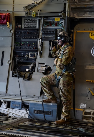 Staff Sgt. William Reed, 16th Airlift Squadron loadmaster, looks out the rear cargo door of a C-17 Globemaster III during the large formation exercise at Joint Base Charleston, S.C., May 22, 2018.