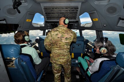 Col. Jimmy Canlas, Airlift Wing commander, talks to civic leaders in the cockpit of a C-17 Globemaster III during the large formation exercise at Joint Base Charleston, S.C., May 22, 2018.