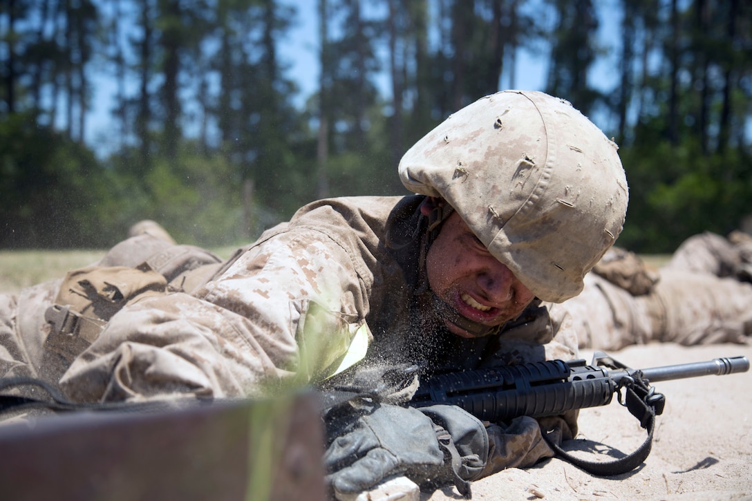 A Marine Corps recruit low crawls during the Crucible training.