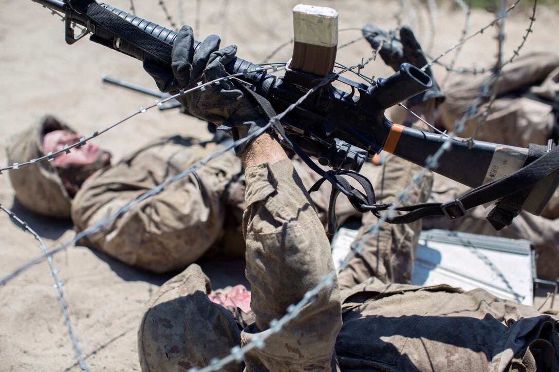 A  Marine Corps recruit goes under a wire obstacle during the Crucible training.