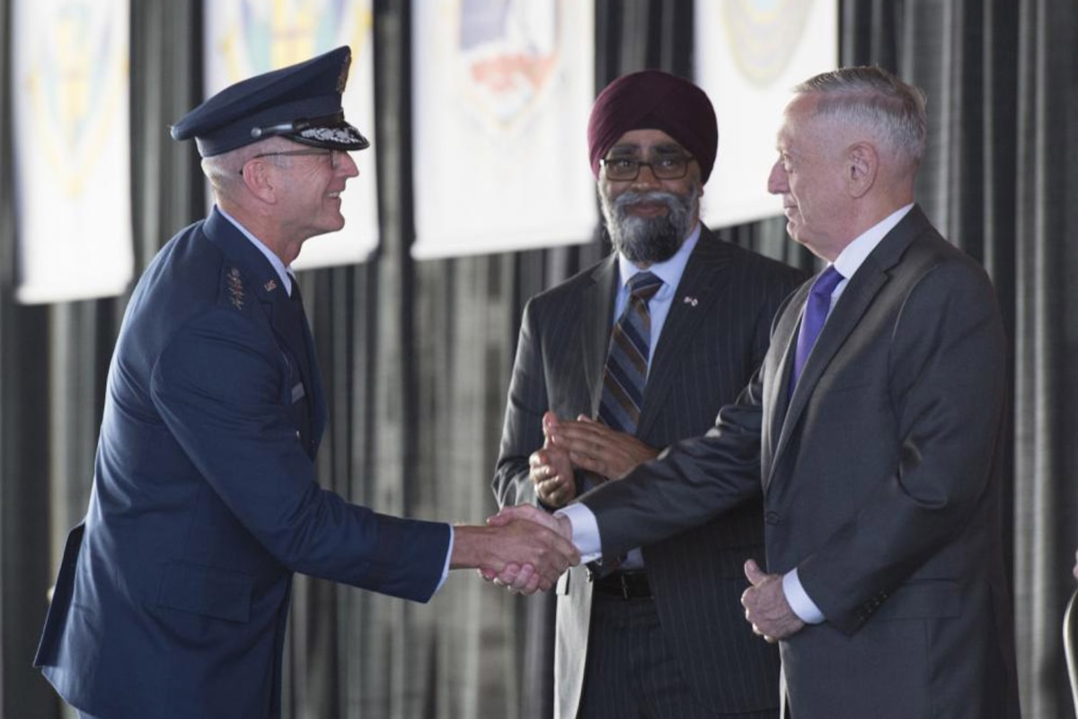 Defense Secretary James N. Mattis shakes hands with Air Force Gen. Terrence J. O’Shaughnessy.