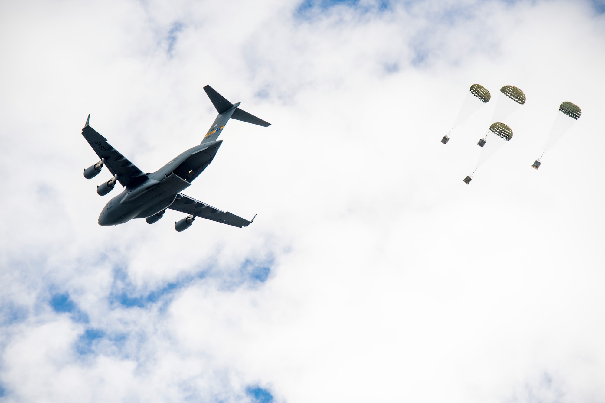 Fifteen C-17 Globemaster III's from the 437th and 315th Airlift Wing, Joint Base Charleston, South Carolina drop heavy platforms and container delivery systems over North Auxiliary Air Field, South Carolina, during an integrated
large formation readiness exercise, May 22, 2018.