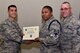 U.S. Air Force Col. Ricky Mills, 17th Training Wing commander, presents Tech. Sgt. Christopher Henry, 316th Training Squadron instructor, their certificate of selection with Chief Master Sgt. Daniel Stein, 17th TRW command chief, during a Master Sergeant release party at the Event Center on Goodfellow Air Force Base, Texas, May 25, 2018. Goodfellow held the party to notify the selected promotees and to give fellow wingmen and friends an opportunity to congratulate them on their success. (U.S. Air Force photo by Senior Airman Randall Moose)