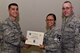 U.S. Air Force Col. Ricky Mills, 17th Training Wing commander, presents Tech. Sgt. Yue Yan Huang, 17th Medical Support Squadron technician, their certificate of selection with Chief Master Sgt. Daniel Stein, 17th TRW command chief, during a Master Sergeant release party at the Event Center on Goodfellow Air Force Base, Texas, May 25, 2018. Goodfellow held the party to notify the selected promotees and to give fellow wingmen and friends an opportunity to congratulate them on their success. (U.S. Air Force photo by Senior Airman Randall Moose)