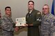 U.S. Air Force Col. Ricky Mills, 17th Training Wing commander, presents Tech. Sgt. Brian Murry, 316th Training Squadron instructor, their certificate of selection with Chief Master Sgt. Daniel Stein, 17th TRW command chief, during a Master Sergeant release party at the Event Center on Goodfellow Air Force Base, Texas, May 25, 2018. Goodfellow held the party to notify the selected promotees and to give fellow wingmen and friends an opportunity to congratulate them on their success. (U.S. Air Force photo by Senior Airman Randall Moose)