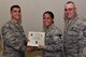 U.S. Air Force Col. Ricky Mills, 17th Training Wing commander, presents Tech. Sgt. Gloria Westbrooks, 17th Mission Support Group executive assistant, their certificate of selection with Chief Master Sgt. Daniel Stein, 17th TRW command chief, during a Master Sergeant release party at the Event Center on Goodfellow Air Force Base, Texas, May 25, 2018. Goodfellow held the party to notify the selected promotees and to give fellow wingmen and friends an opportunity to congratulate them on their success. (U.S. Air Force photo by Senior Airman Randall Moose)