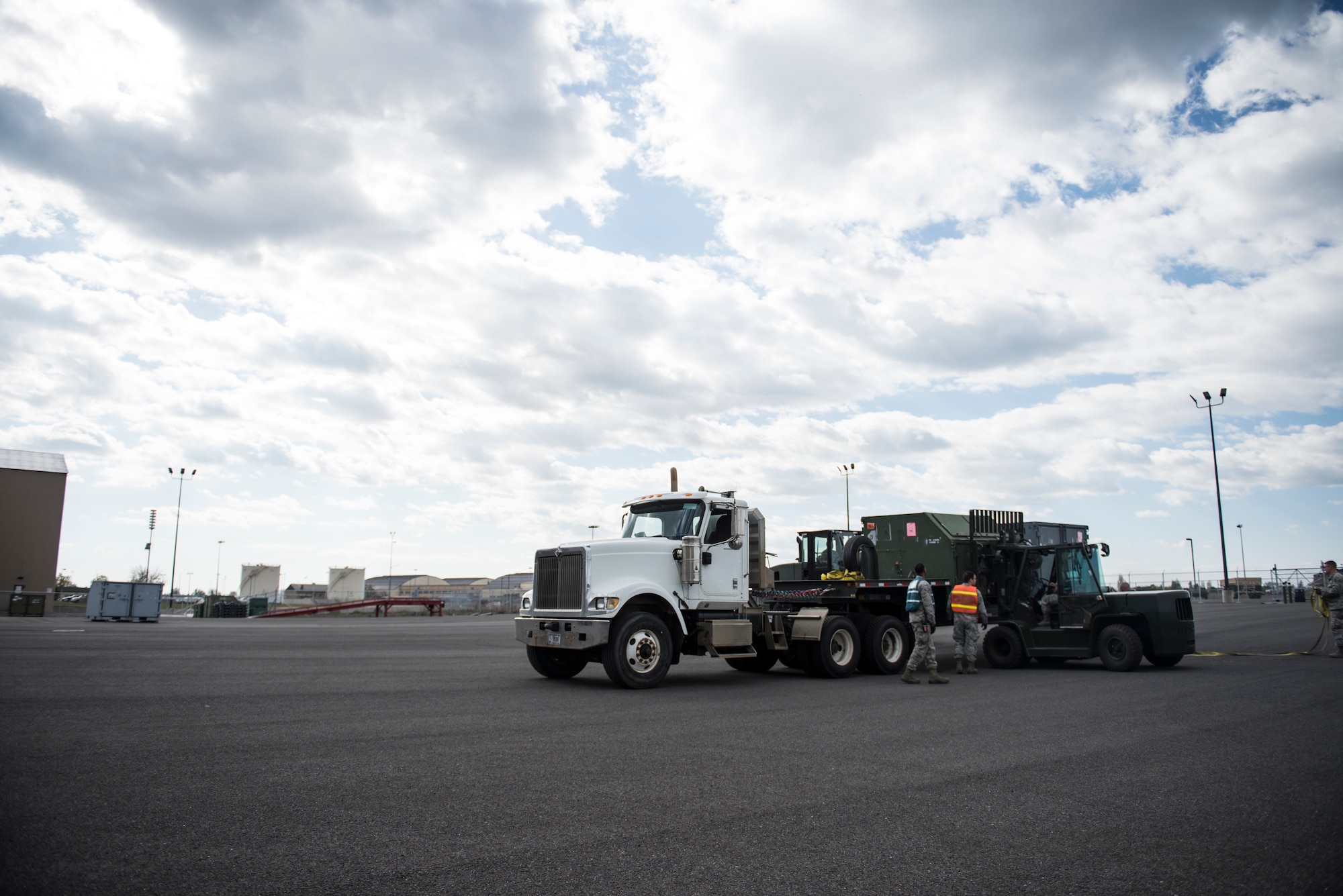 Fairchild Airmen conduct a cargo load during an exercise at Fairchild Air Force Base, Washington, May 2, 2018. The Cargo Deployment Function line begins when a request for cargo is submitted. Once the base meets the requestor’s needs, it is then processed. The cargo is then palletized and transported to its destination. The process involves more than just paperwork; it involves preparing baggage pallets, marshalling and driving forklifts, weighing and measuring cargo and checking hazardous material. (U.S. Air Force Photo/Senior Airman Sean Campbell)