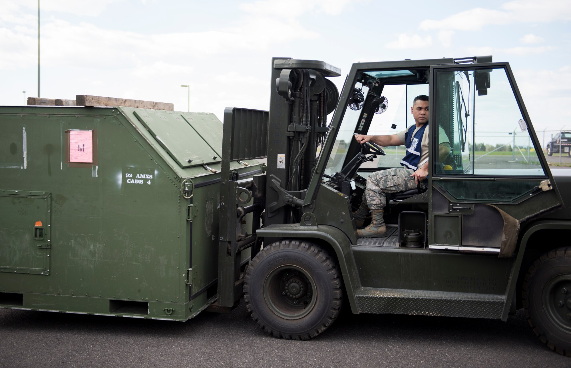 Tech. Sgt. Jaymhar Caoile, 92nd Logistics Readiness Squadron assistant resource advisor, operates a forklift during an exercise at Fairchild Air Force Base, Washington, May 2, 2018. The Cargo Deployment Function process involves more than just paperwork; it involves preparing baggage pallets, marshalling and driving forklifts, weighing and measuring cargo and checking hazardous material. (U.S. Air Force Photo/Senior Airman Sean Campbell)