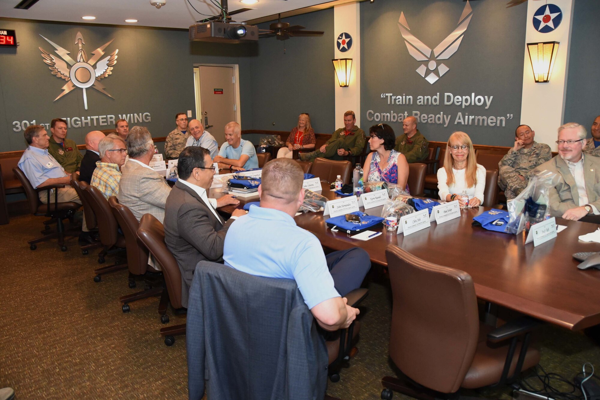 Community leaders gather for a briefing by 
Col. Gregory C. Jones, 301st Fighter Wing commander, May 18, 2018, at Naval Air Station Fort Worth Joint Reserve Base, Texas. The event's goal was to enhance the understanding of the wing's mission and capabilities for those recently inducted into the Honorary Commanders' Program. (U.S. Air Force photo by Tech. Sgt. Charles Taylor)