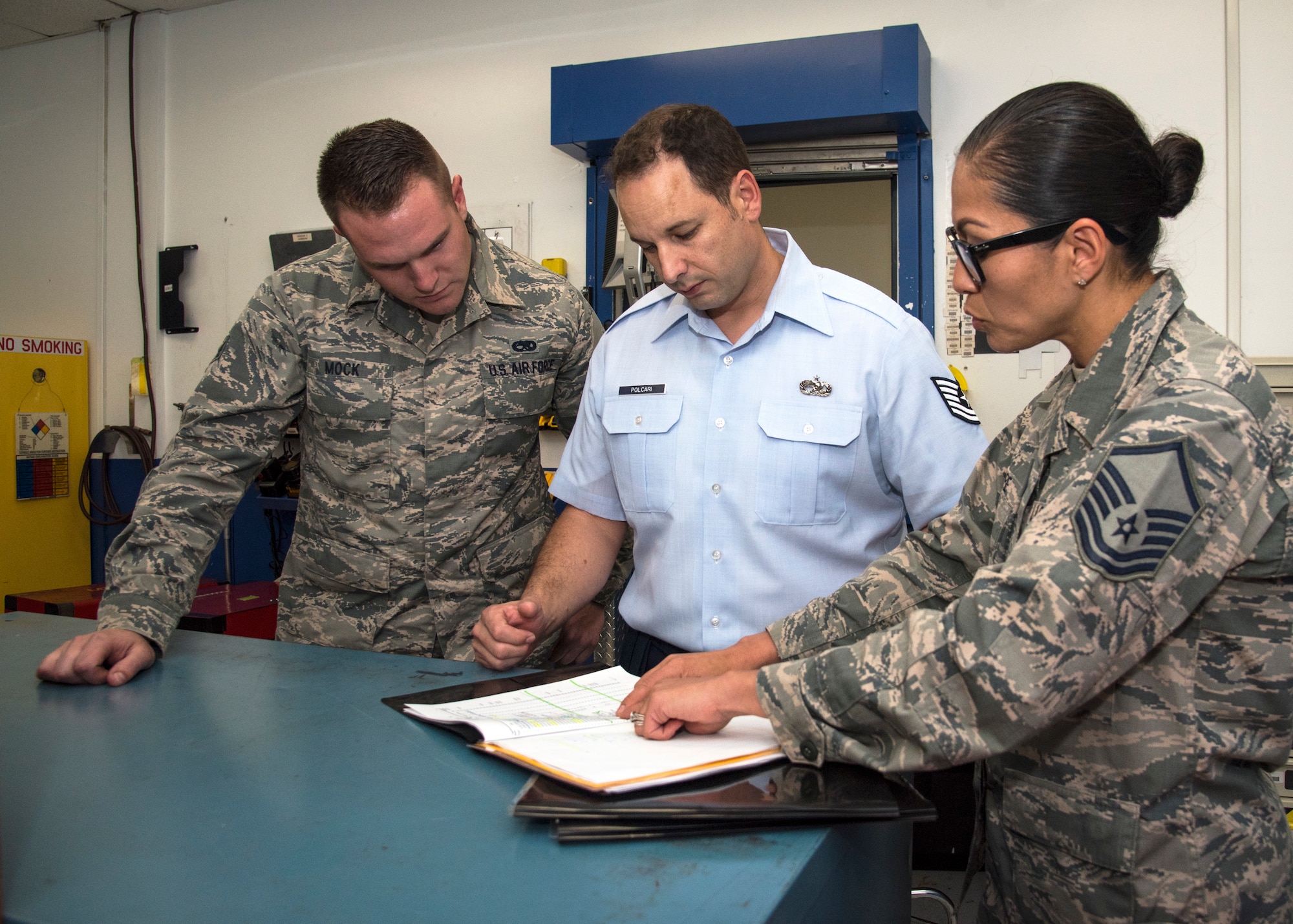U.S. Air Force Master Sgt. Mandy Thorpe, right, lead inspection planner assigned to the 6th Air Mobility Wing Inspector General office, reviews 6th Maintenance Squadron (MXS) unit type codes with Tech. Sgt. Patrick Polcari, center, 6th MXS unit deployment manager and Senior Airman Jean-Paul Mock, 6th MXS aircraft structural journeyman, left, during a Horizontal Inspection at MacDill Air Force Base, Fla., April 30, 2018. This inspection is a wing-level program that verifies the readiness of multiple units.