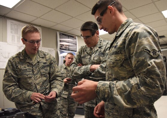 U.S. Air Force Airman 1st Class Jacob St. John and Airman Trent Olson, 85th Engineering Installation Squadron cable antennae technicians, provide Lt. Gen. Bradford J. “BJ” Shwedo, Office of the Secretary of the Air Force, Chief Information Dominance and Chief Information Officer, at the Pentagon, Washington, D.C., with a fiber optic splicing demonstration during a tour at Maltby Hall at Keesler Air Force Base, Mississippi, May 22, 2018. In order to become more familiar with Keesler’s training mission, Shwedo also toured squadrons within the 81st Training Group. (U.S. Air Force photo by Kemberly Groue)
