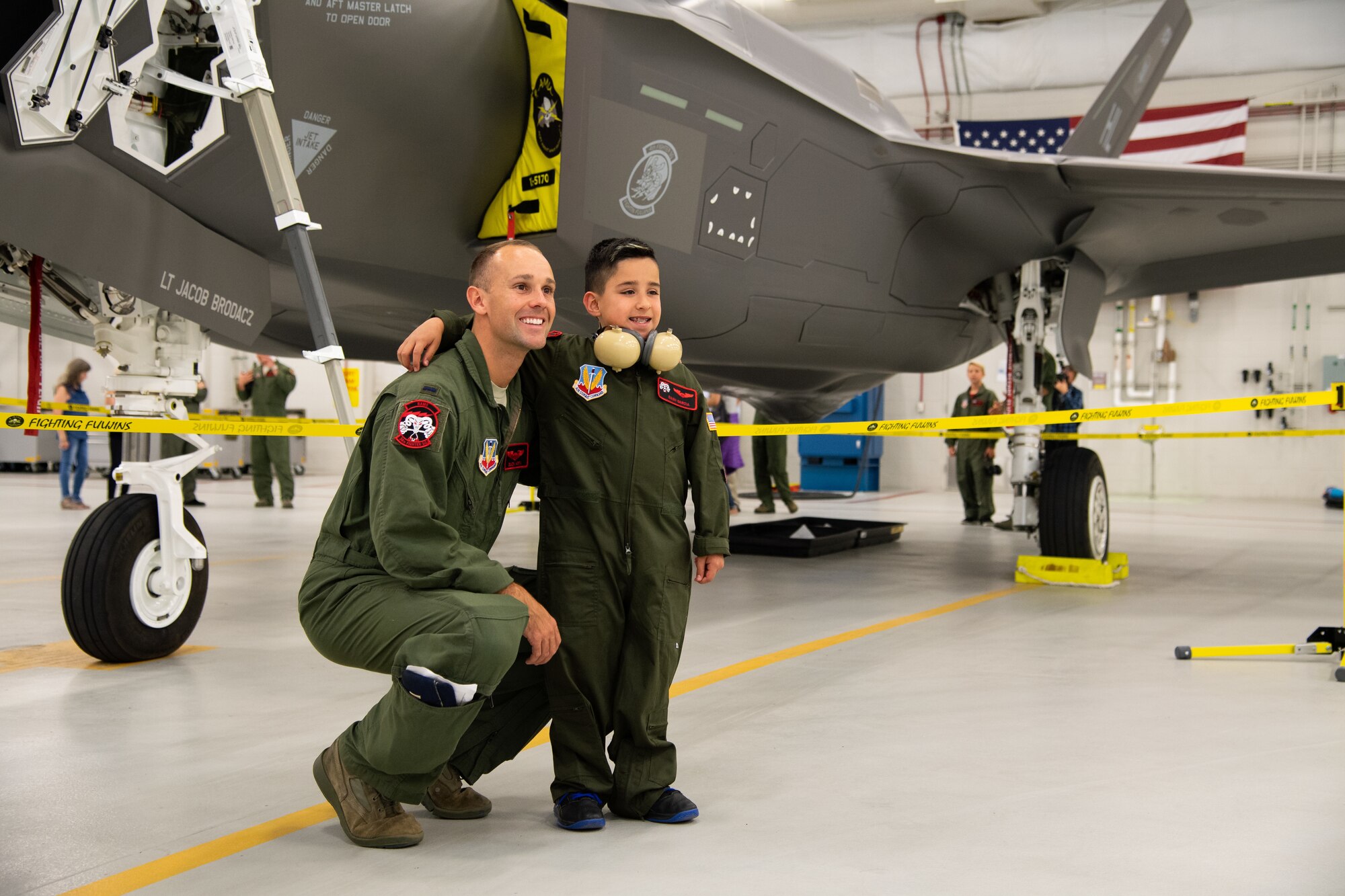 Dash Garcia poses for a photo with 1st Lt. John Horn, May 24, 2108, at Hill Air Force Base, Utah. Eight children and their parents from Make-A-Wish Utah visited Hill for the "Pilot for a Day" program. The children toured the base, visited with pilots and "flew" in an F-35A cockpit trainer during the event. (U.S. Air Force photo by R. Nial Bradshaw)