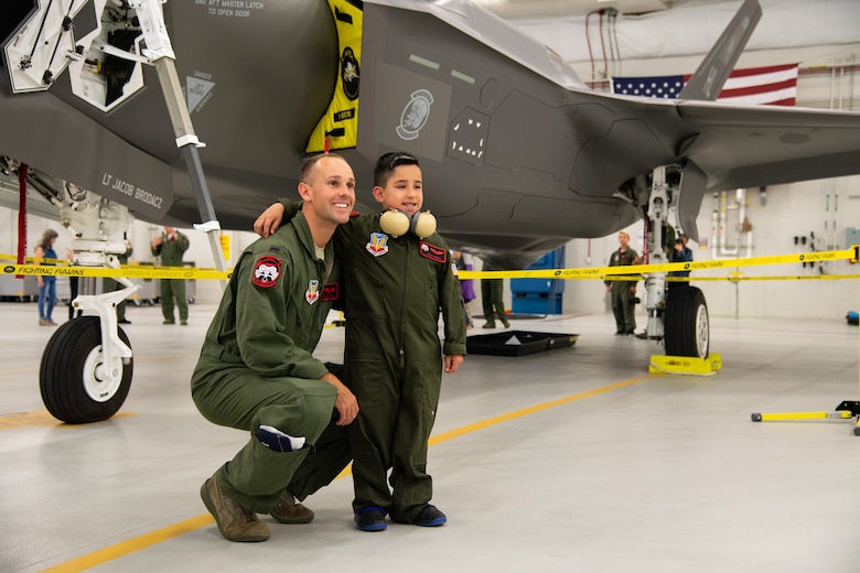 Dash Garcia poses for a photo with 1st Lt. John Horn, May 24, 2108, at Hill Air Force Base, Utah. Eight children and their parents from Make-A-Wish Utah visited Hill for the "Pilot for a Day" program. The children toured the base, visited with pilots and "flew" in an F-35A cockpit trainer during the event. (U.S. Air Force photo by R. Nial Bradshaw)