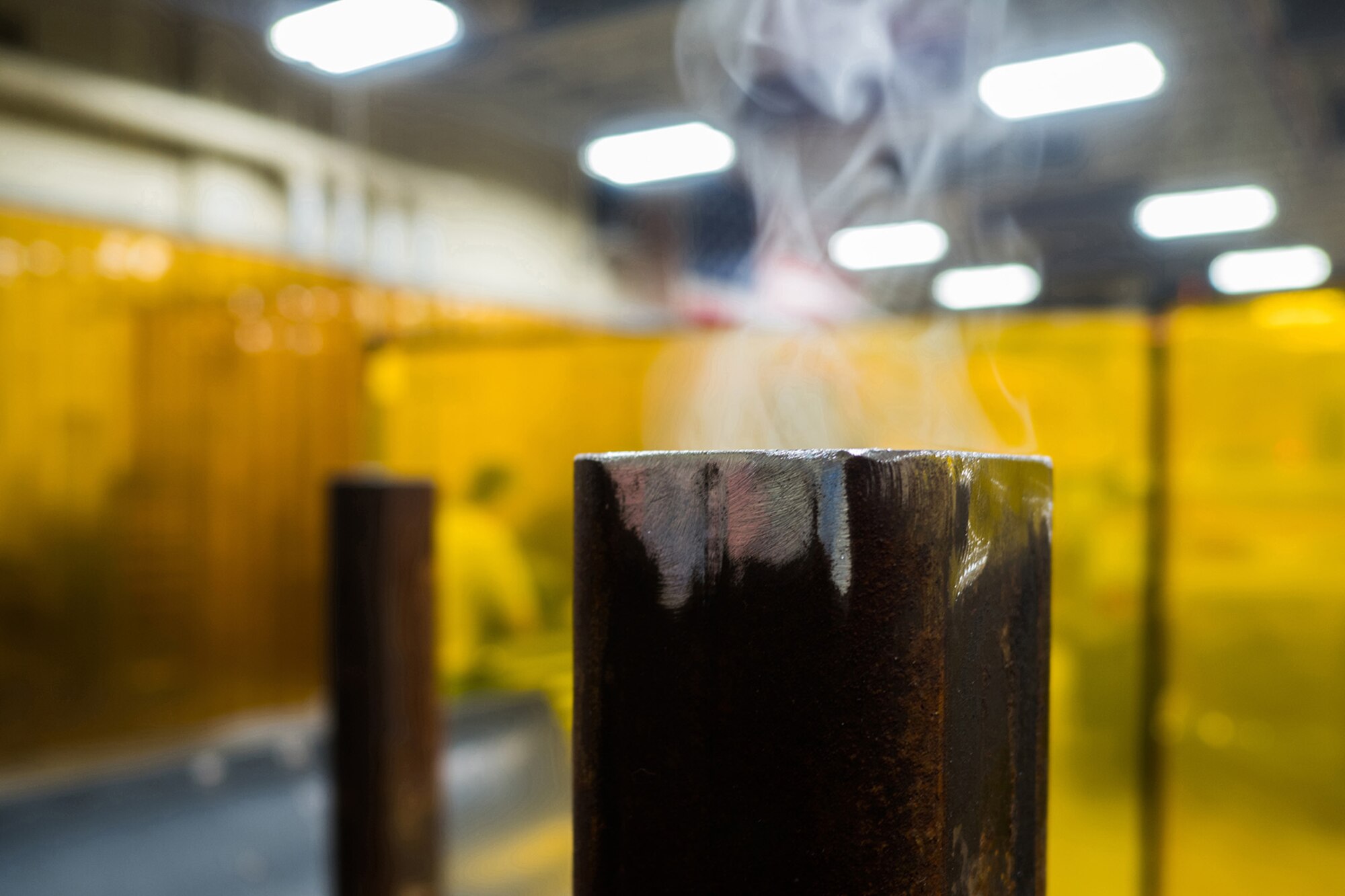 Smoke rises from a welded piece of metal in the metals fabrication shop on Joint Base Elmendorf-Richardson, Alaska, May 9, 2018. Aircraft Metals Technology Airmen measure broken or worn parts, draw working sketches, make templates, perform precision grinding remove poisonous or corrosive deposits from parts, and write programs for machines using manual and computer-aided manufacturing.