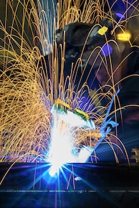 Airman Dalton Sturtz, a native of Seguin, Texas, an aircraft metals technology journeyman assigned to the 3rd Maintenance Squadron, practices welding a metal plate in the metals fabrication shop on Joint Base Elmendorf-Richardson, Alaska, May 9, 2018. Aircraft Metals Technology Airmen measure broken or worn parts, draw working sketches, make templates, perform precision grinding remove poisonous or corrosive deposits from parts, and write programs for machines using manual and computer-aided manufacturing.