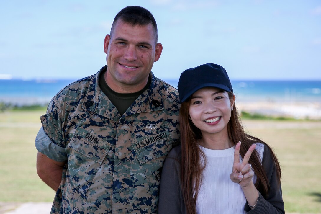 Gunnery Sgt. Scott Michael Dahn, left, and Ching-Yi Sze, left, come together after Dahn rescued Ching-Yi while scuba diving May 20, 2018 at Maeda Point, Okinawa, Japan. Dahn brought Ching Yi, a Hong Kong native, to safety after she nearly drowned while scuba diving and supplied oxygen and care to her until paramedics came. Dahn, a native of Herron, Michigan, is the training chief for 3rd Maintenance Battalion, 3rd Marine Logistics Group, III Marine Expeditionary Force and a native of Herron, Michigan. (U.S. Marine Corps photo by Lance Cpl. Andrew Neumann)