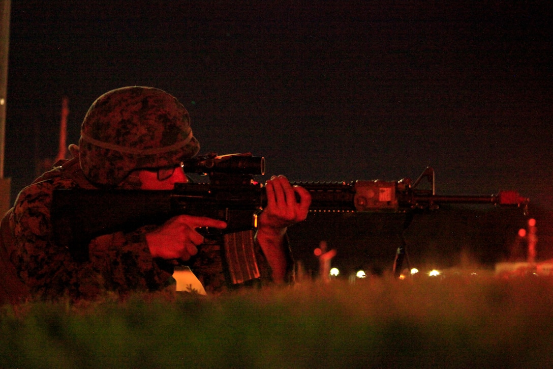 U.S. Marine Corps Lance Cpl. Jeffrey Grosin, a military police officer with 3rd Law Enforcement Battalion, III Marine Expeditionary Force, provides security during a low-light assault, May 22, 2018, at White Beach Naval Facility, Okinawa, Japan.  The exercise tested the Marines’ ability to use nonlethal force, operate entry control points and process crime scene evidence. Grosin is a native of Stony Point, New York. (U.S. Marine Corps photo by Cpl. Jonah Baase)