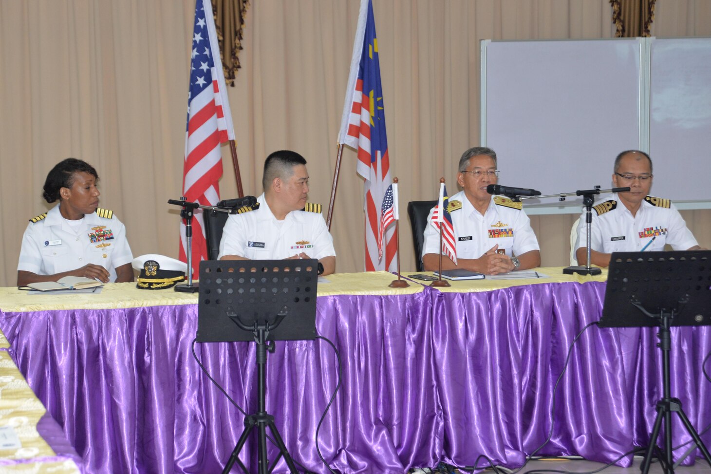Capt. Tracy Hines, left, Assistant Chief of Staff for U.S. 7th Fleet’s Information Systems and Networks (N6) directorate and Capt. Bernard Wang, center, 7th Fleet Plans and Theater Security Cooperation (TSC) director and senior officer on the 7th Fleet TSC patrol, listen as Royal Malaysian Navy leaders give opening remarks during the 2018 bilateral Fleet Staff Talks.