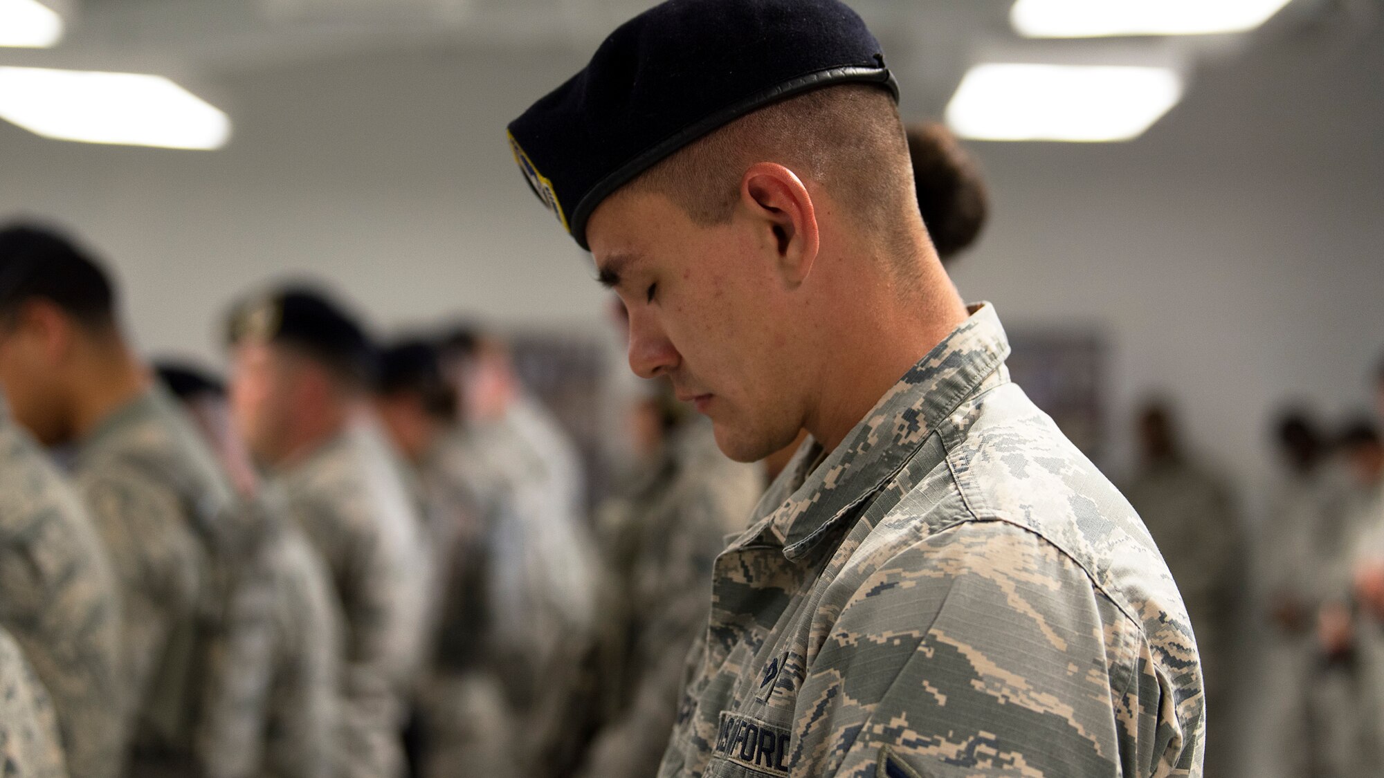 An Airmen of the 6th Security Forces Squadron bows his head during a moment of silence in remembrance of fallen law enforcement officers at MacDill Air Force Base, Fla., May 21, 2018. The ceremony was held as part of Police Week, which included other events such as a 24-hour vigilance run and a kickball game.