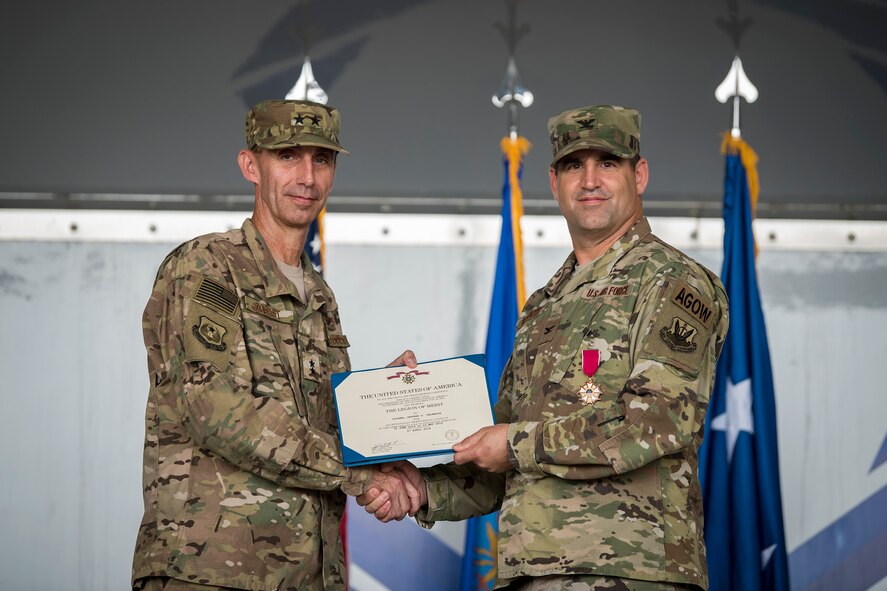 U.S. Air Force Maj. Gen. Scott J. Zobrist, left, 9th Air Force commander, presents Col. Jeffrey Valenzia, 93d Air Ground Operations Wing (AGOW) outgoing commander, with a Legion of Merit during a change of command ceremony, May 23, 2018, at Moody Air Force Base, Ga. The 93d AGOW activated in 2008 and became the first wing to provide highly trained ground combat forces capable of integrating air and space power into the ground scheme of fire and maneuver. They also provide forces capable of employing air power activities in close coordination with land operations, including combat weather support to land forces. (U.S. Air Force photo by Airman 1st Class Eugene Oliver)