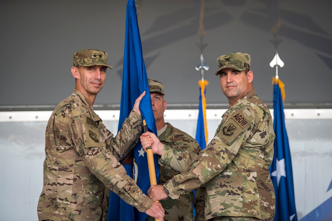 U.S. Air Force Col. Jeffrey Valenzia, right, 93d Air Ground Operations Wing (AGOW) outgoing commander, passes the guidon to Maj. Gen. Scott J.  Zobrist, 9th Air Force commander, during a change of command ceremony, May 23, 2018, at Moody Air Force Base, Ga. The 93d AGOW is comprised of 2,800 battlefield Airmen at more than 20 locations across the continental U.S. Those locations include three operational groups, 17 squadrons, 10 detachments and 12 operating locations.  (U.S. Air Force photo by Airman 1st Class Eugene Oliver)