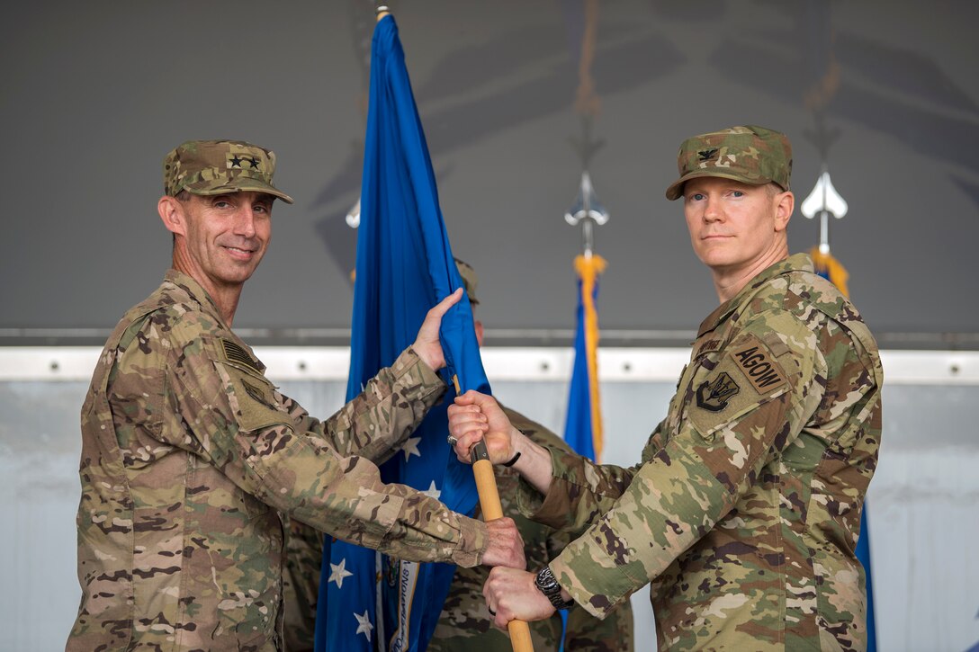 U.S. Air Force Maj. General Scott J. Zobrist, left, 9th Air Force Commander, passes the guidon to Col. Paul Birch, 93d Air Ground Operations Wing (AGOW) incoming commander, during a change of command ceremony, May 23, 2018, at Moody Air Force Base, Ga. The passing of the guidon represents the official changing of leadership and symbolizes who members in a unit owe their allegiance. This event marks the beginning of a new regime as Birch becomes the 7th commander of the 93rd AGOW. (U.S. Air Force photo by Airman 1st Class Eugene Oliver)
