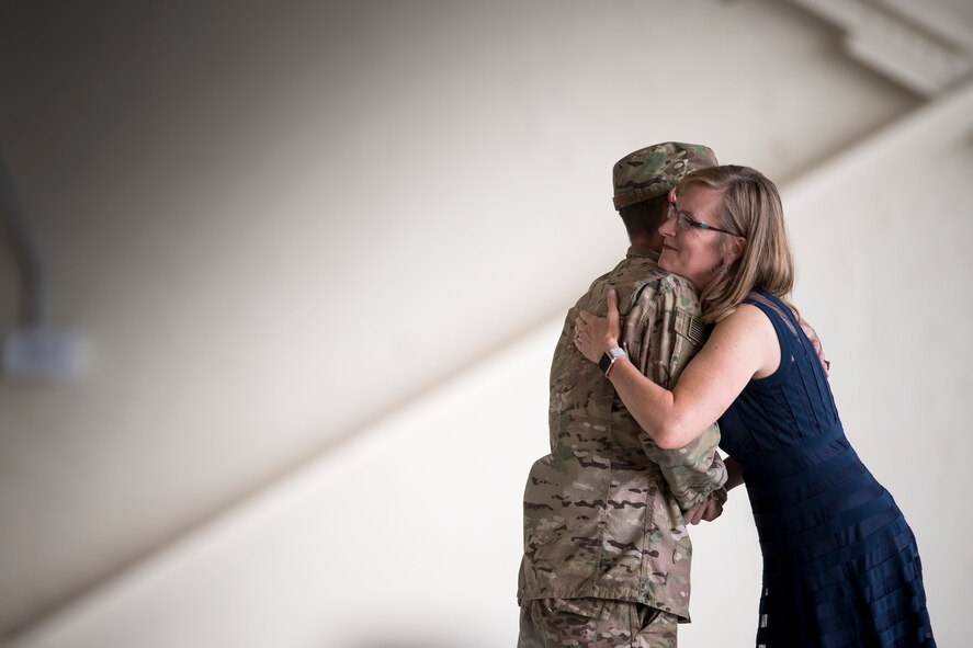 Maj. Gen. Scott Zobrist, 9th Air Force commander, hugs JoAnne Valenzia, wife of Col. Jeffery Valenzia, after presenting her with a coin, May 23, 2018, at Moody Air Force Base, Ga. After relinquishing command Valenzia will assume duties as the executive assistant to the North American Aerospace Defense Command/U.S. Northern Command commander at Peterson Air Force Base, Colo. (U.S. Air Force photo by Staff Sgt. Ryan Callaghan)