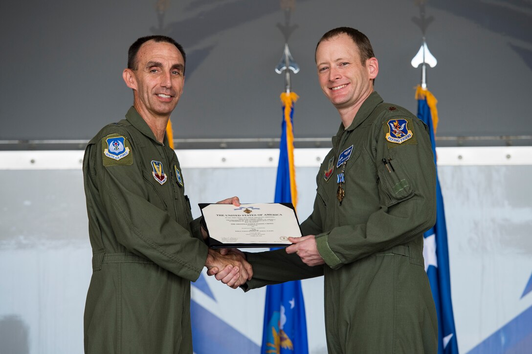 U.S. Air Force Maj. Gen. Scott J. Zobrist, left, 9th Air Force commander, presents Maj. Matthew “Chowder”’ Cichowski, 74th Fighter Squadron A-10C Thunderbolt II pilot, with a Distinguished Flying Cross with valor during an award ceremony, May 23, 2018, at Moody Air Force Base, Ga. Cichowski and his wingman were outnumbered 3-to-1 Jan. 9, 2018, when providing close-air-support for ground forces. Through his efforts, Cichowski identified 25 enemy fighters and employed a 2,000 pound Joint Direct Attack Munition to thwart the enemy. (U.S. Air Force photo by Senior Airman Janiqua P. Robinson)