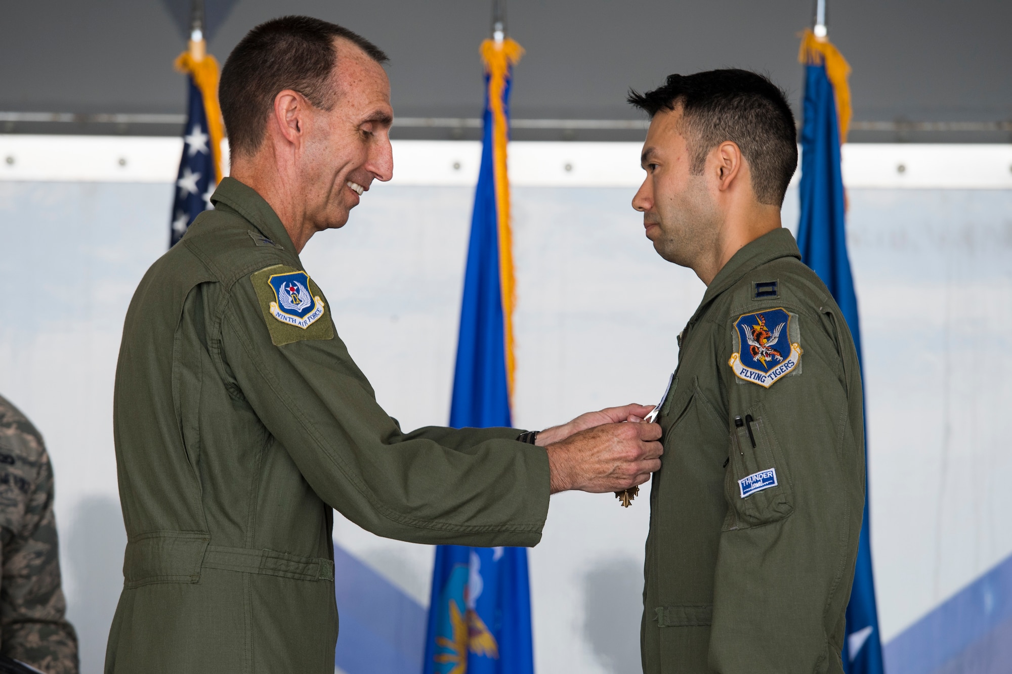 U.S. Air Force Maj. Gen. Scott Zobrist, left, 9th Air Force commander, places a Distinguished Flying Cross medal on Capt. William “Archer” Dana, 74th Fighter Squadron A-10C Thunderbolt II pilot, during an award ceremony, May 23, 2018, at Moody Air Force Base, Ga. Dana, along with his wingman, was alerted Aug. 14, 2017, by a Joint Terminal Attack Controller the enemy had breached friend lines in eight locations. In a three-hour period, Dana employed 11,000 pounds of ordnance and destroyed 10 enemy defensive fighting positions. (U.S. Air Force photo by Senior Airman Janiqua P. Robinson)