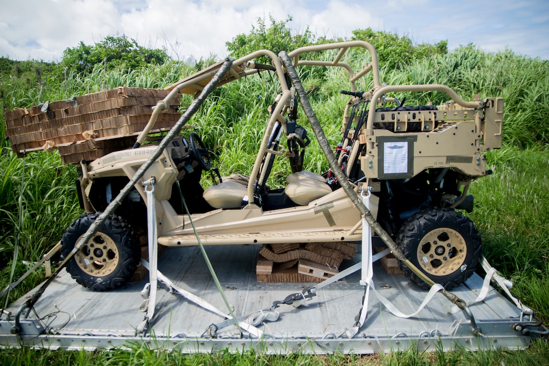 A Polaris MRZR lands after being dropped from a C-130 May 22, 2018, on Ie Shima, Okinawa, Japan. Marines conducted air drop operations dropping a type-five platform, door bundles, free fall and static line jumpers, and the Polaris MRZR onto the island. 3rd Marine Logistics Group Marines worked alongside Marines with 3rd Reconnaissance Battalion, 3rd Marine Division, during the regularly scheduled training evolution to complete their first ever successful drop of a Polaris MRZR from a C-130.
