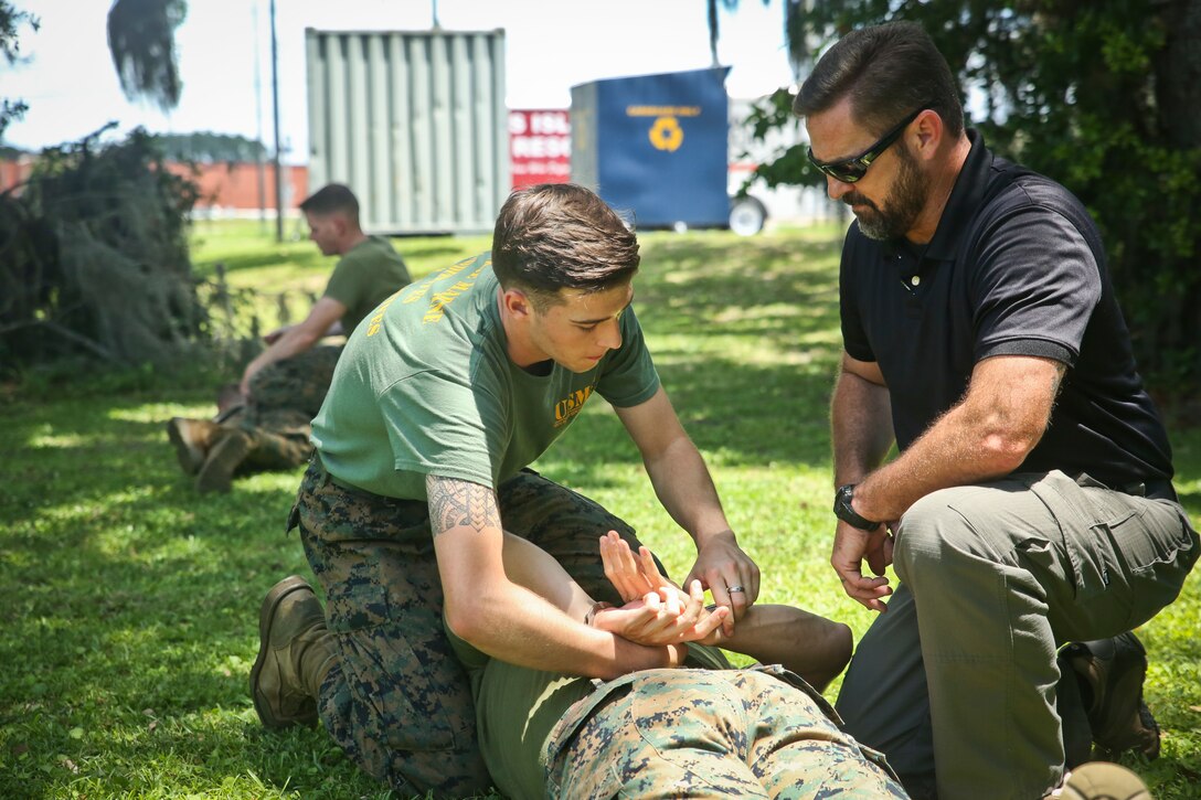 Ron Videtto, right, shows Cpl. Jacob Blea restraining techniques as part of Security Augmentation Force training aboard Marine Corps Recruit Depot Parris Island May 23. SAF is a detail of Marines selected to assist the Provost Marshal’s Office with security in emergency situations. Blea is an administrative specialist with Headquarters and Headquarters Squadron and Videtto is with PMO.