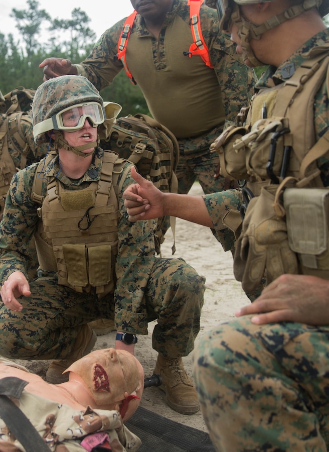 Petty Officer 3rd Class Emilie Evans, hospital corpsman, 22nd Marine Expeditionary Unit, directs the placement of a simulated casualty during the Tactical Evacuation Course at Camp Lejeune, N.C., May 23, 2018. The Tactical Evacuation Course trained hospital corpsman the proper techniques to use in unusual evacuation environments.  (U.S. Marine Corps photo by Lance Cpl. Tawanya Norwood)