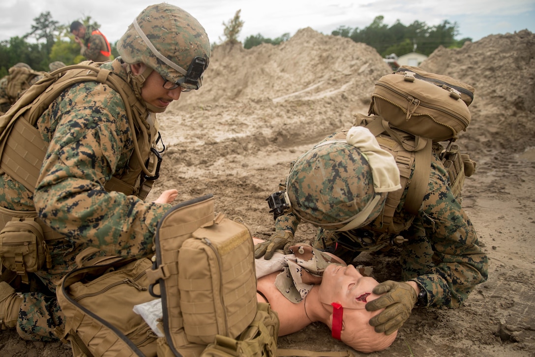 Petty Officer 3rd Class Emilie Evans, hospital corpsman, 22nd Marine Expeditionary Unit, directs the placement of a simulated casualty during the Tactical Evacuation Course at Camp Lejeune, N.C., May 23, 2018. The Tactical Evacuation Course trained hospital corpsman the proper techniques to use in unusual evacuation environments.  (U.S. Marine Corps photo by Lance Cpl. Tawanya Norwood)