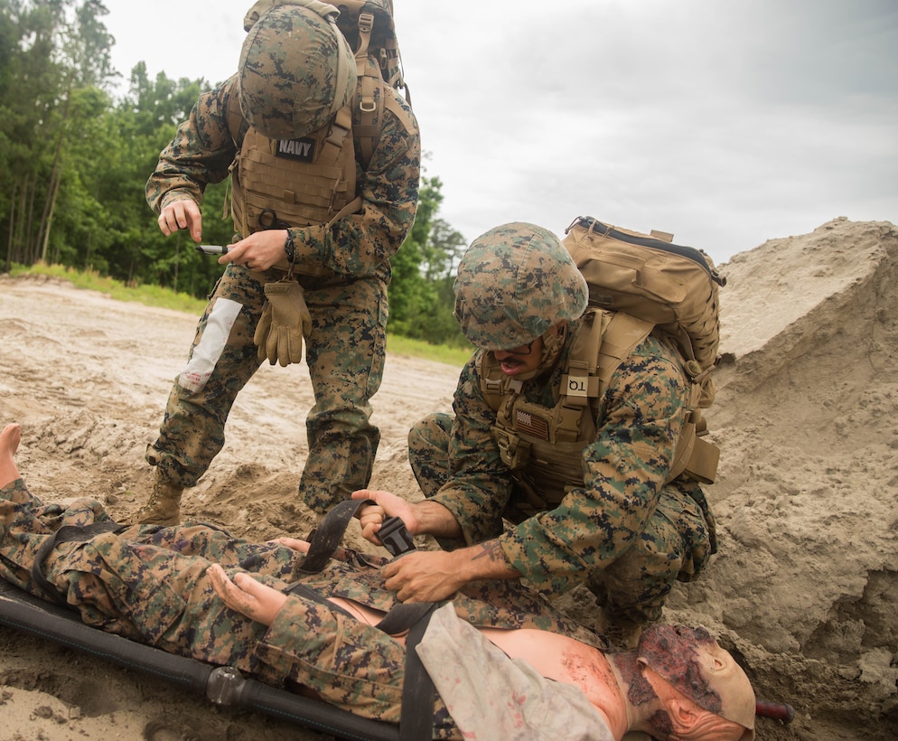 Petty Officer 3rd Class Emilie Evans, hospital corpsman, 22nd Marine Expeditionary Unit, directs the placement of a simulated casualty during the Tactical Evacuation Course at Camp Lejeune, N.C., May 23, 2018. The Tactical Evacuation Course trained hospital corpsman the proper techniques to use in unusual evacuation environments.  (U.S. Marine Corps photo by Lance Cpl. Tawanya Norwood)