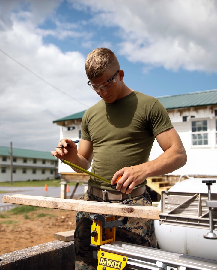 U.S. Marine Private First Class Jeffrey Beasley, combat engineer with Engineer Company C, 6th Engineer Support Battalion, 4th Marine Logistics Group, measures and marks a cut line on a wooden plank at a construction site during exercise Red Dagger at Fort Indiantown Gap, Pa., May 23, 2018. Exercise Red Dagger is a bilateral training exercise that gives Marines an opportunity to exchange tactics, techniques and procedures as well as build working relationships with their British counterparts. (U.S. Marine Corps photo by Sgt. Melanie Wolf/Released)