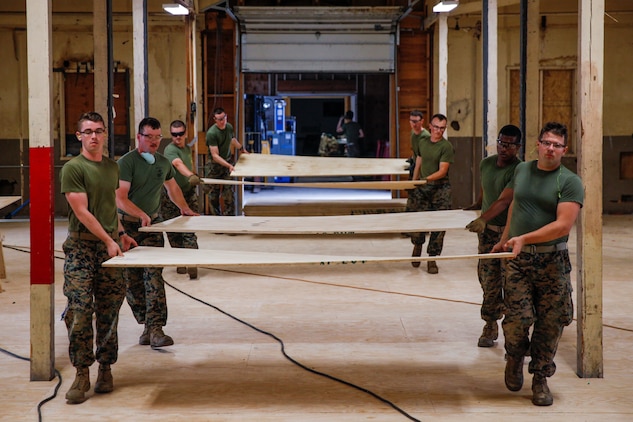 U.S. Marines with 6th Engineer Support Battalion, 4th Marine Logistics Group, carry plywood  at a construction site during exercise Red Dagger at Fort Indiantown Gap, Pa., May 23, 2018.